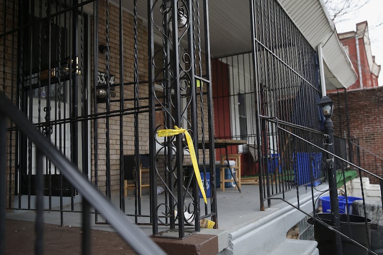 Police tape hangs off a porch beam next to a home where a woman was fatally shot overnight in the 6300 block of North Woodstock Street in North Philadelphia on Friday, Dec. 14, 2018. The woman was reportedly shot next to her newborn infant. TIM TAI / Staff Photographer