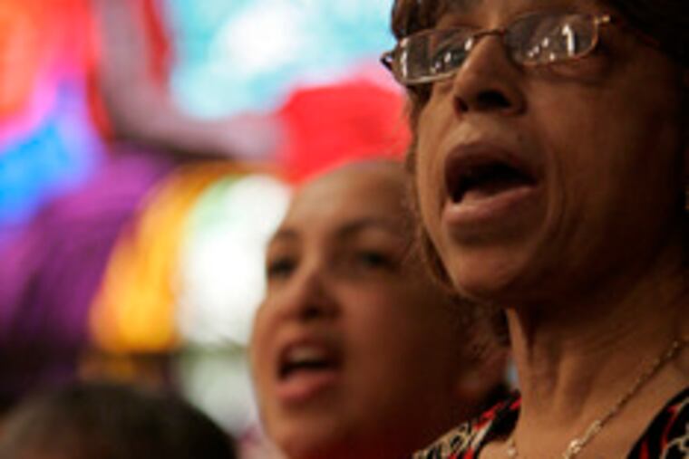 Dorothy Taylor and other participants raise their voices in song on the last day of the weeklong workshop.