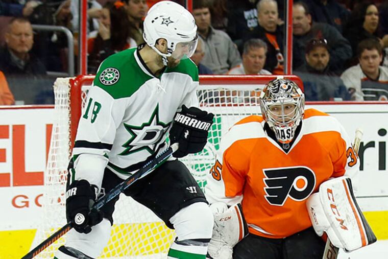 Flyers' goalie Steve Mason stops the puck against Stars' Patrick Eaves. (Yong Kim/Staff Photographer)
