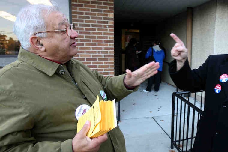 Bill Saba (left), a Democrat, and Ron Matlack, a Republican, have a "friendly" disagreement at a Bucks County polling place.