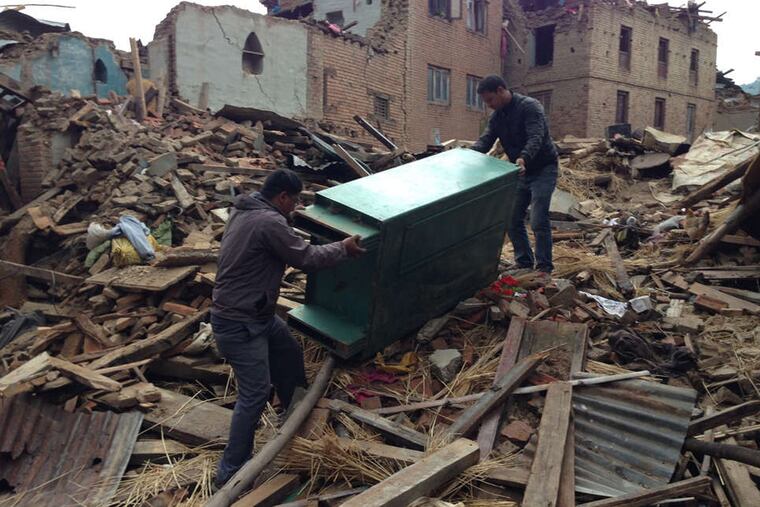 Salvaging furniture from the quake's wreckage in Nepal. In villages that were destroyed, most homes were made of unfired brick and clay mortar.