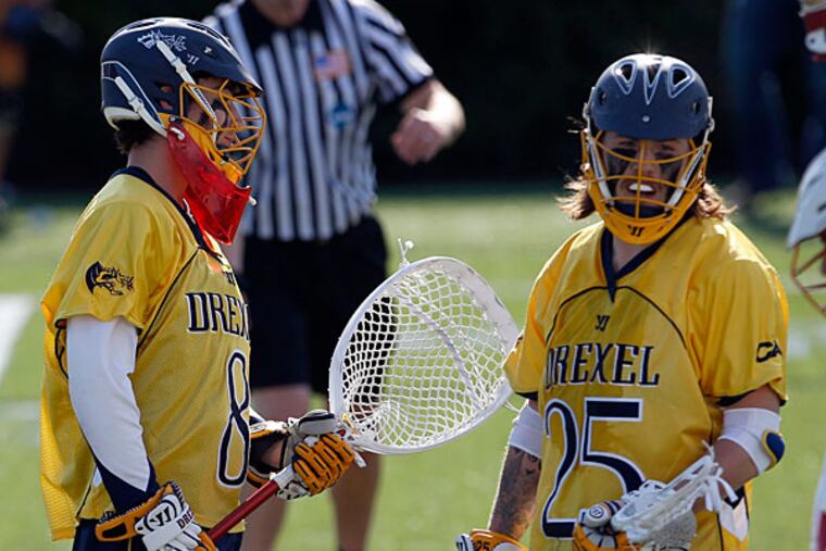 Drexel goalie Will Gabrielsen (left) and teammate Pat Root (center). (Yong Kim/Staff Photographer)