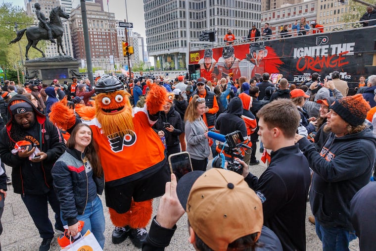 Gritty poses for pictures with Flyers fan during rally bus stop on north side of Philadelphia City Hall to meet up with fans as team enters the playoffs. Photograph taken on Monday, April 20, 2026.
