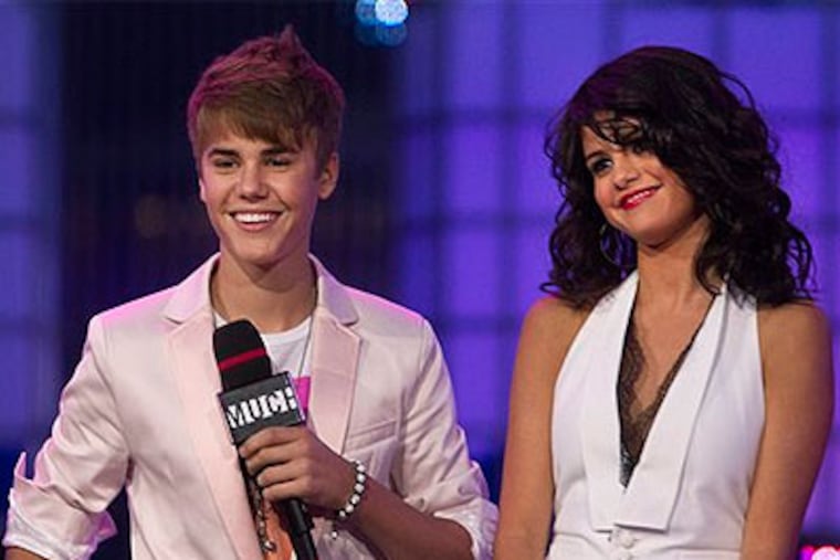 File Photo - Justin Bieber and girlfriend Selena Gomez standing on stage during the 2011 MuchMusic Video Awards in Toronto. Bieber is no longer Gomez’s ‘Boyfriend,’ a source confirms to the AP. The split happened last week and distance and their busy schedules were a contributing factor. Eighteen-year-old Bieber is currently touring to promote his album, while 20-year-old Gomez is filming a “Wizards of Waverly Place” reunion for Disney Channel called “The Wizards Return."