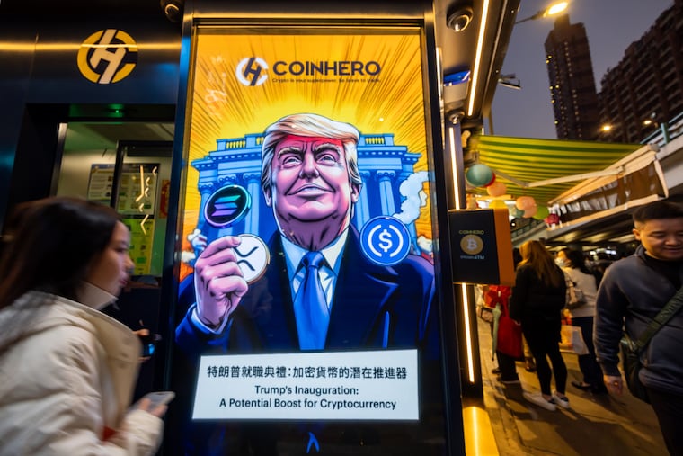 A cartoon image of Donald Trump with cryptocurrency tokens, depicted in front of the White House, to mark his inauguration, at a store in Hong Kong.