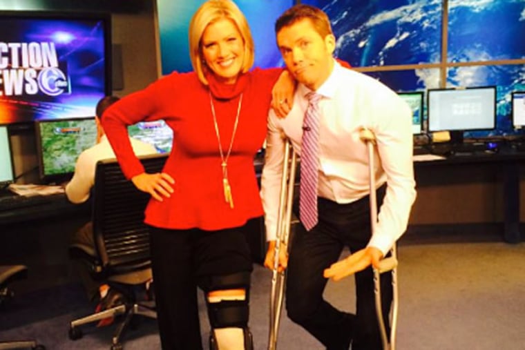 Cecily Tynan's in her ski-accident cast, along with colleague/crutch-stealer Adam Joseph. (Photo via Tynan's Twitter)