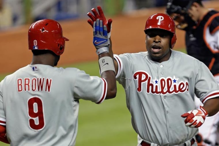 Domonic Brown (9) congratulates teammate Delmon Young (right) on his solo home run against the Miami Marlins in the fourth inning of a baseball game in Miami, Wednesday, May 22, 2013. (Alan Diaz/AP)
