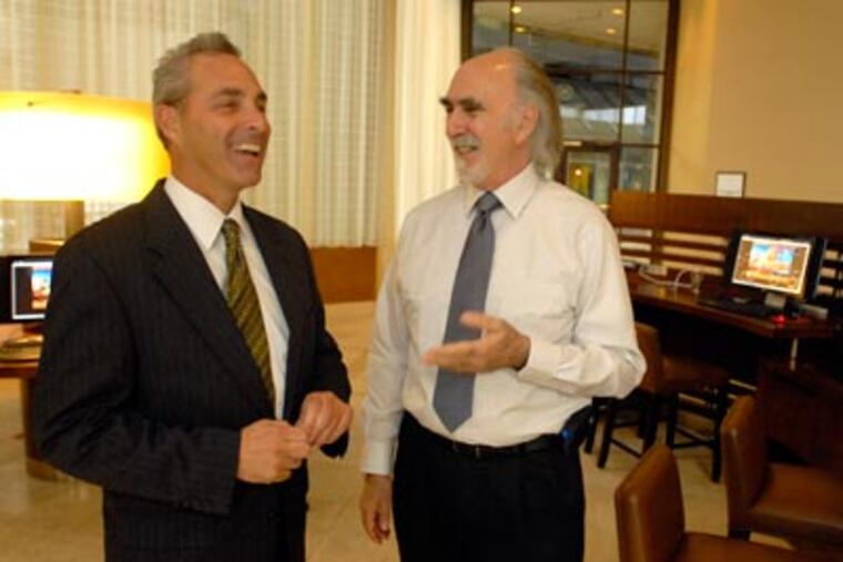 “You can see it in our lobby after 5 p.m. It’s teeming with corporate types,” says the Sheraton Philadelphia City Center’s Paul Schwartz (left). He is with salesman Alan Tepper, at the hotel for the second week in a row. (Ron Tarver / Staff Photographer)