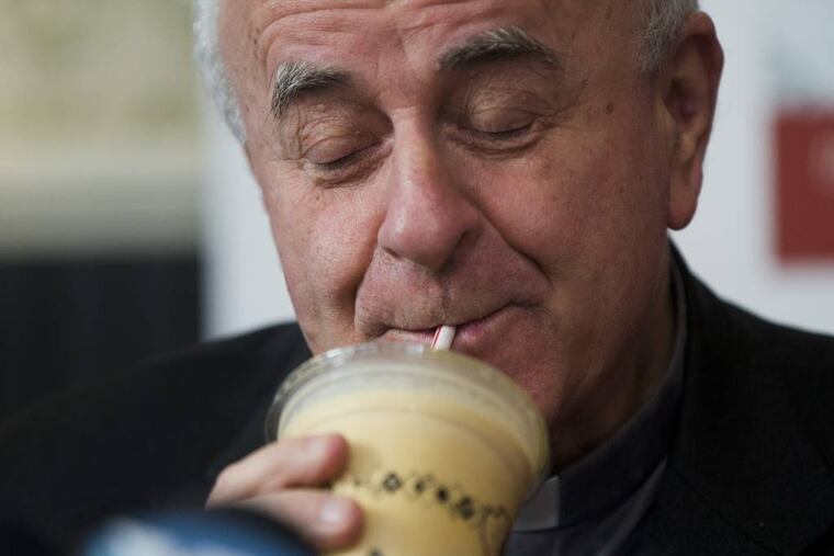 Archbishop Vincenzo Paglia samples a milkshake during a news conference to pick a milkshake for the upcoming World Meeting of Families, Monday, March 9, 2015, at a Potbelly Sandwich Shop in Philadelphia. (AP Photo/Matt Rourke)