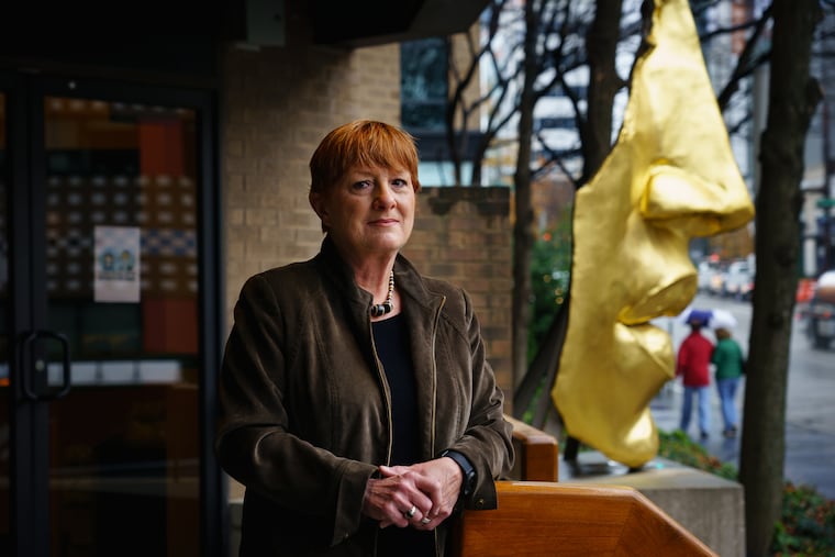 Pam Dalton, a scientist who studies the nose, including mucus, stands outside the Monell Chemical Senses Center, in front of the sculpture "Face Fragment,” by Philadelphia sculptor Arlene Love.