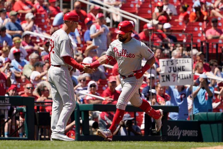 Kyle Schwarber (right) is congratulated by third base coach Dusty Wathan after hitting a solo home run in the fifth inning Sunday against the St. Louis Cardinals. Schwarber has 28 homers this season.