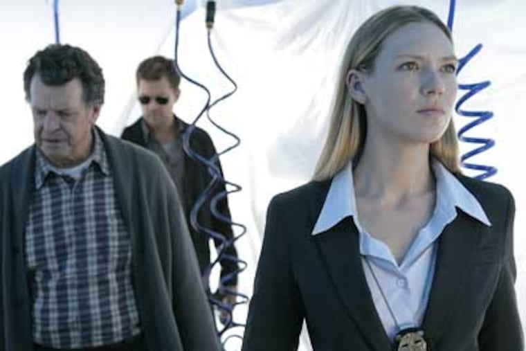 Anna Torv stars as Agent Olivia Dunham, right, John Noble stars as Dr. Walter Bishop, left, and Joshua Jackson stars as Peter Bishop in a scene from "Fringe." (AP Photo/FOX, Craig Blankenhron)