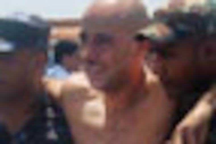 ALTERNATE CROP OF AKCF101- Plane crash survivor Andreas Rasch, center, from Denmark is helped by rescue workers after being flown for treatment to the nearby city of Pokhara, Nepal, Monday, May 14, 2012. A plane crashed into a mountain in the Himalayas while trying to land at Jomsom Airport, 200 kilometers (125 miles) northwest of the capital, Katmandu, Monday, killing 15 people and critically injuring six. (AP Photo/Santosh Pokharal)