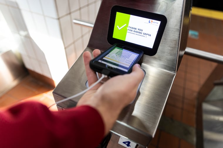 A Temple student scans his ticket on the SEPTA’s beta mobile ticket app at Cecil B Moore stop on the Broad Street Line.