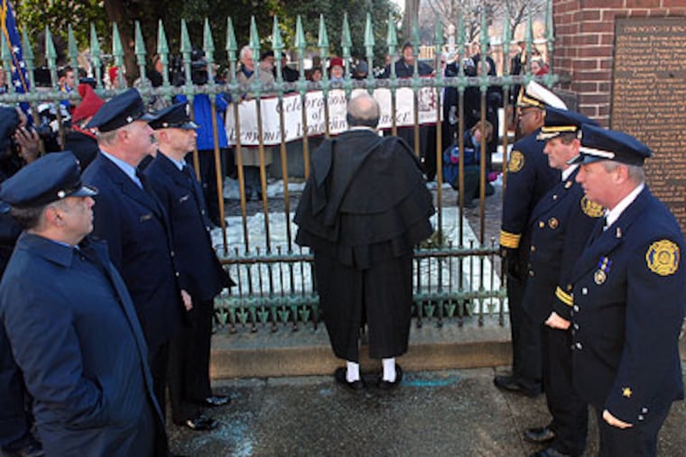 Ralph Archbold as Ben Franklin, who started the nation's first fire department in 1736, stands between a fire department honor guard offering up hoorays Friday outside Franklin's grave. The ceremony marked the 305th anniversary of Franklin's birthday. (Tom Gralish / Staff Photographer)