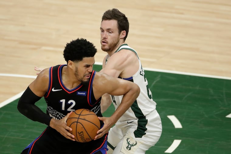 Tobias Harris (12) drives to the basket against the Bucks' Pat Connaughton.