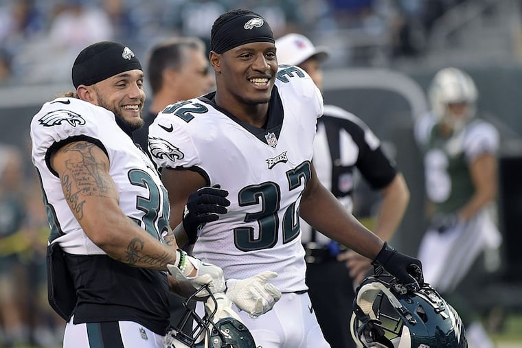 Philadelphia Eagles’ Aaron Grymes, left, and Rasul Douglas talk to teammates prior to an NFL football game against the New York Jets, Thursday, Aug. 31, 2017, in East Rutherford, N.J.