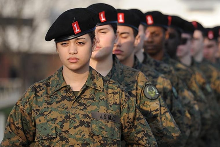 Cadet Natalie Nieves, a 9th grader at Coatesville High School, and her fellow students who participate in the Joint Service Military Club, stand at ease in the school parking lot after doing some drills and exercises Dec. 3, 2013. ( CLEM MURRAY / Staff Photographer )