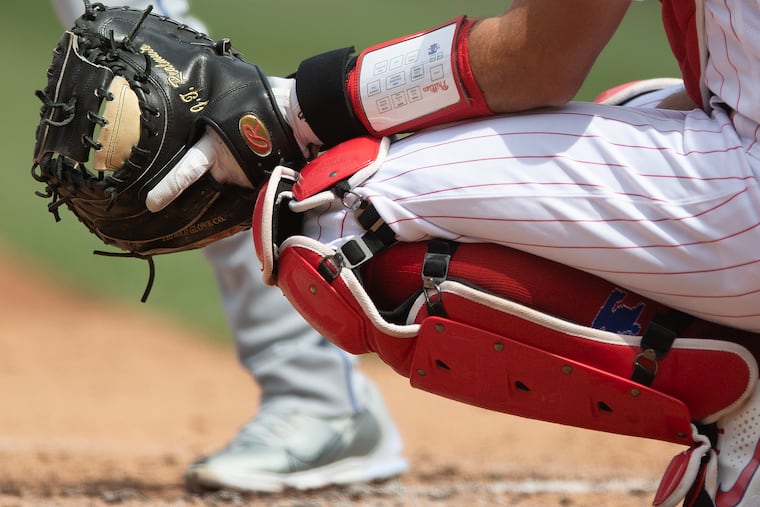 Phillies catcher J.T. Realmuto wears the PitchCom transmitter (in black) on his wrist to send his pitch calls to the pitcher.