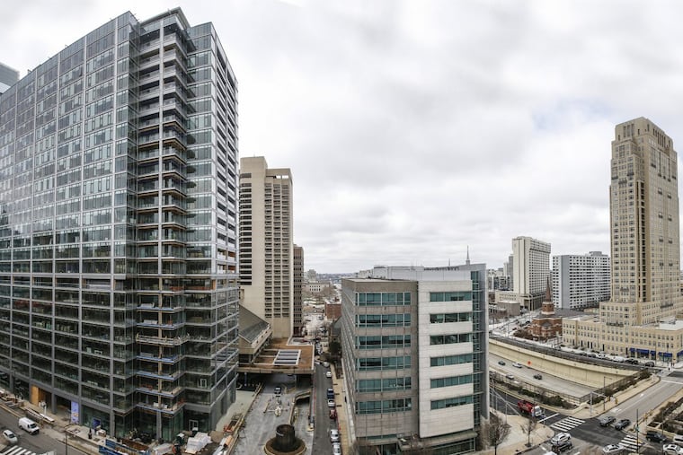 This collage, which merges two photos, shows how much new density has been created on either side of the Vine Street Expressway by two new apartment buildings, the Franklin Tower (left) and The Alexander at 16th and Vine. The midrise building now houses the String Theory charter high school.