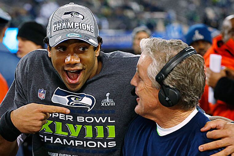 Seahawks quarterback Russell Wilson and head coach Pete Carroll. (Paul Sancya/AP)