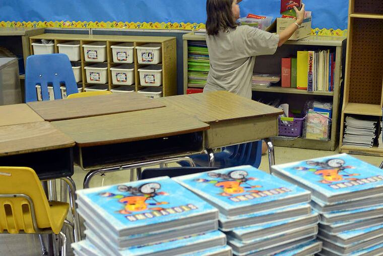 Second grade teacher Jennifer Straka prepares her classrom at Prince Hall School, August 22, 2013 as the K-5 school readies for its Sept. 9 opening. ( TOM GRALISH / Staff Photographer )