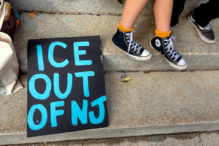 A sign “ICE OUT OF NJ” as Mi Casa Woodbury and Cooper River Indivisible hold a “roadside rally” in downtown Woodbury, N.J., in support of immigrants and to protest ICE on Sunday, Jan. 11, 2026, as protests against Trump administration actions spread in the suburbs.