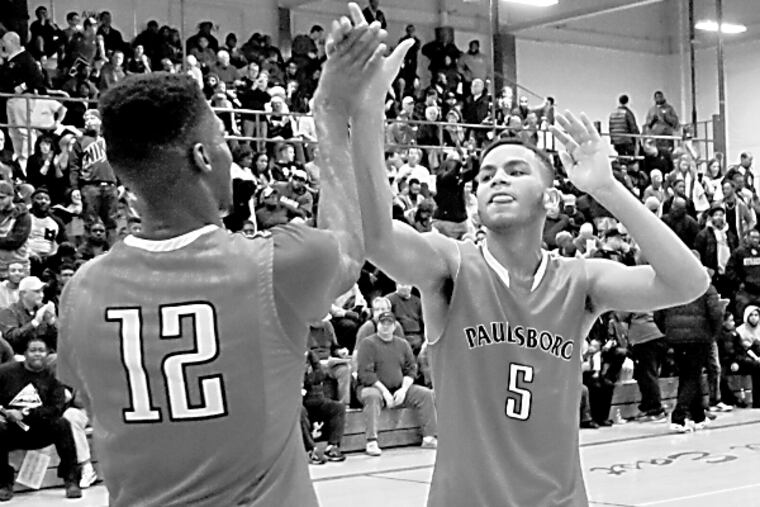 Paulsboro's Theo Holloway , left, and Cherron Quarles celebrate after they defeated Camden on Saturday afternoon. (Curt Hudson/Staff Photographer)