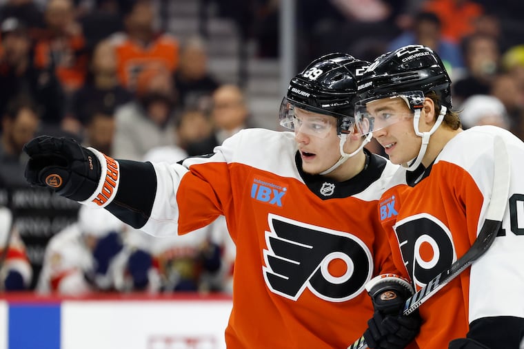 Flyers right wing Matvei Michkov talks to teammate right wing Bobby Brink during a recent game against the Florida Panthers.