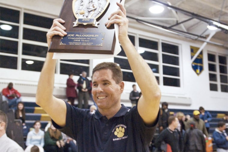Collinswood coach Joe McLoughlin hold up a plaque honoring his 200th win. (Ron Tarver / Staff Photographer)