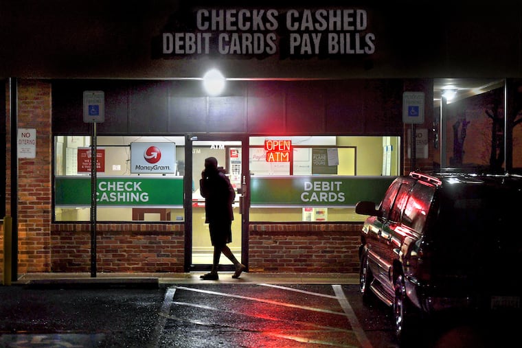 A customer leaves a payday loan store in Gaithersburg, Md. Predatory financial practices like payday lending have contributed to distrust of financial systems among Black Americans, says Jason Ray of Philadelphia's Zenith Wealth Partners.