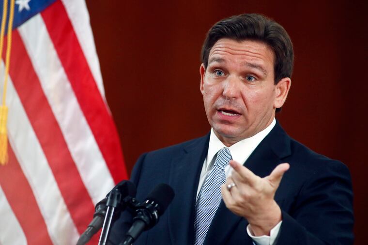 Florida Gov. Ron DeSantis answers questions from the media earlier this month at the state Capitol in Tallahassee, Fla.