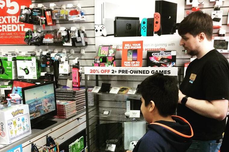 Gaming customers at GameStop shop at the Cherry Hill Shopping Center location. The store is the third-largest in the company by sales.
