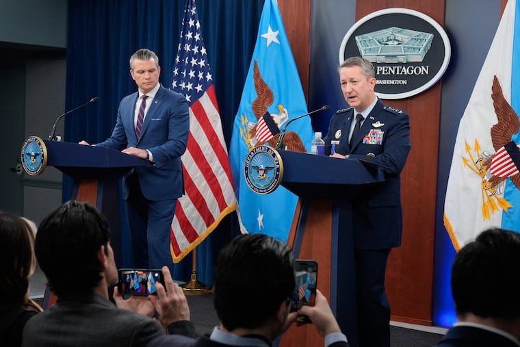 Defense Secretary Pete Hegseth and Gen. Dan Caine, chairman of the Joint Chiefs of Staff, speak during a news briefing Monday at the Pentagon.