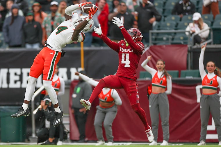 Miami wide receiver Colbie Young (left) makes a touchdown catch over Temple safety Tywan Francis in the first half Saturday at Lincoln Financial Field.