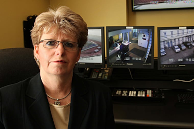 Maureen Rush, of the University of Pennsylvania's Division of Public Safety, amid state-of-the-art video surveillance equipment that monitors the campus. (Laurence Kesterson / Staff Photographer)