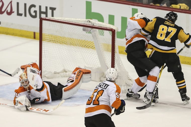 Goalie Michal Neuvirth makes a glove save against Pittsburgh’s Sidney Crosby with 50 seconds left in Game 5 and the Flyers leading, 3-2. They won, 4-2.