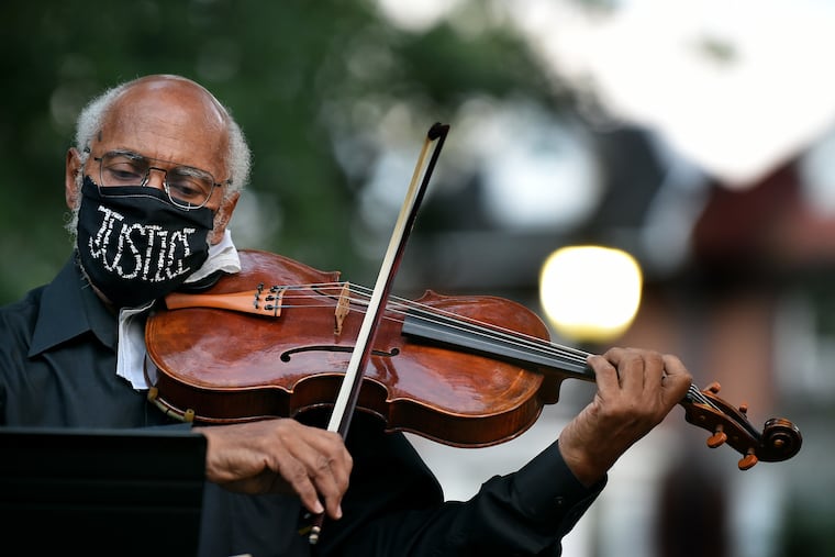 Renard Edwards, a violist with the Philadelphia Orchestra, plays with other string musicians during a candlelight vigil and short concert in memory of Elijah McClain in Malcolm X Park on Wednesday night. McClain, a 23-year-old massage therapist and violinist, died last summer a few days after police in Colorado detained him, placed him in a carotid hold, and injected him with a sedative. String vigils have been held in New York, Boston, Chicago, and dozens of other cities for him and other Black Americans killed by police.
