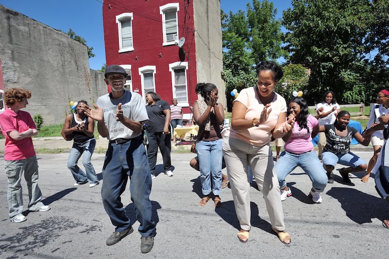 Vaux Roberts High School in Philadelphia threw a block party for the community, and they were dancing in the streets. In the front of the line are Larry Brooks(left), community volunteer and Ruth Birchett, of the School Advisory Council.