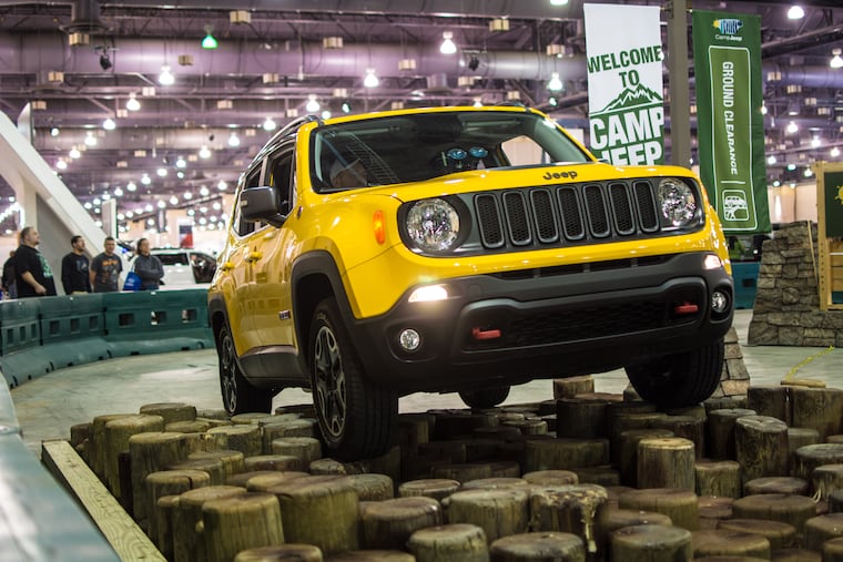 Representatives for Camp Jeep show off their latest models by inviting attendants to participate in a short obstacle course at the 2016 Philadelphia Auto Show.