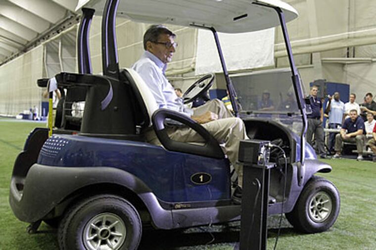 Joe Paterno delivered his media day press conference remarks from a golf cart. (Gene J. Puskar/AP)
