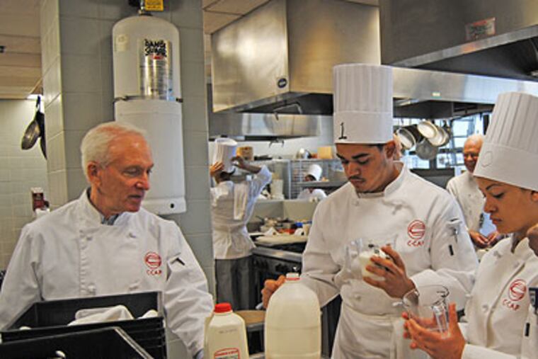 In the kitchen from left to right are Richard Grassman, Ricardo Calcano and Kathy Tavares from Frankford.