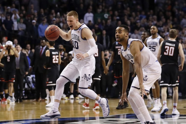 Villanova guard Donte DiVincenzo and guard Phil Booth celebrate after beating Texas Tech in the East Regional Finals on Sunday, March 25, 2018 at the TD Garden in Boston. Villanova reaches the Final Four.