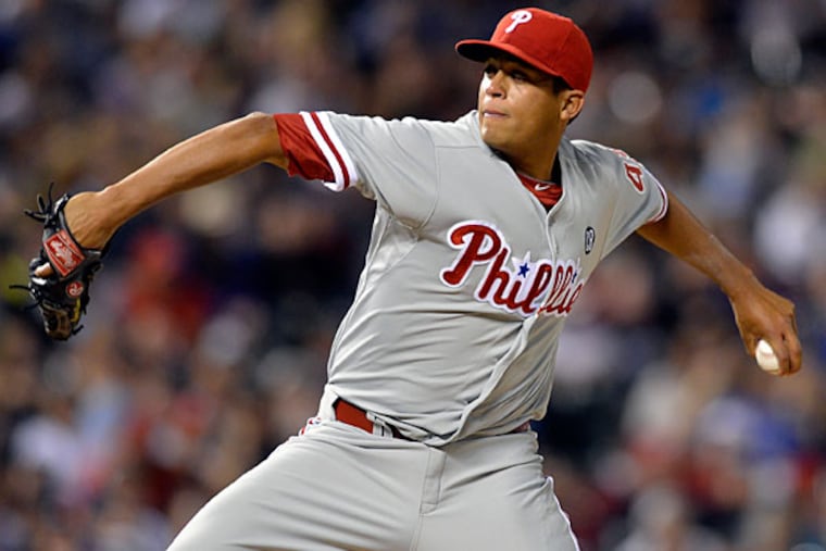Mario Hollands (43) throws to the plate against the Colorado Rockies during the sixth inning of a baseball game on Friday, April 18, 2014, in Denver. (Jack Dempsey/AP)