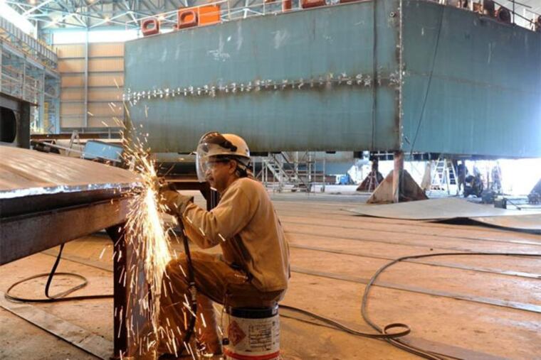 At Aker Philadelphia Shipyard, Lewis Pierce, 55, of Williamstown, grinds a plate for the hull of a ship under construction. The company has also restarted an apprenticeship program that was suspended in July 2010.