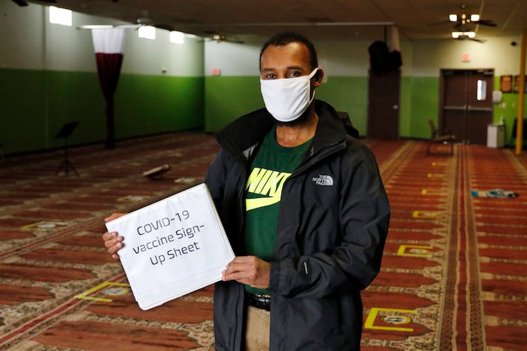 Abdiaziz Mohamed, who is in charge of coordinating vaccines for the Maine Muslim Community Center poses Wednesday, April 7, 2021 in the prayer room of the Maine Muslim Community Center in Portland, Maine.