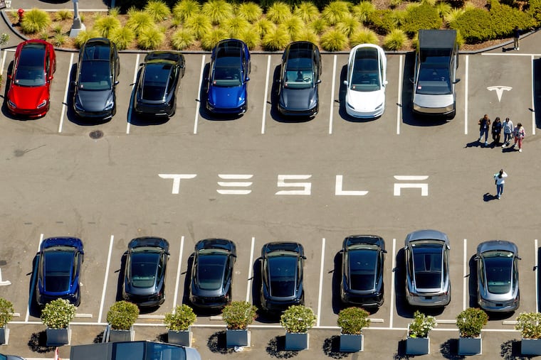Tesla vehicles line a parking lot at the company's Fremont, Calif., factory on Aug. 5, 2025.