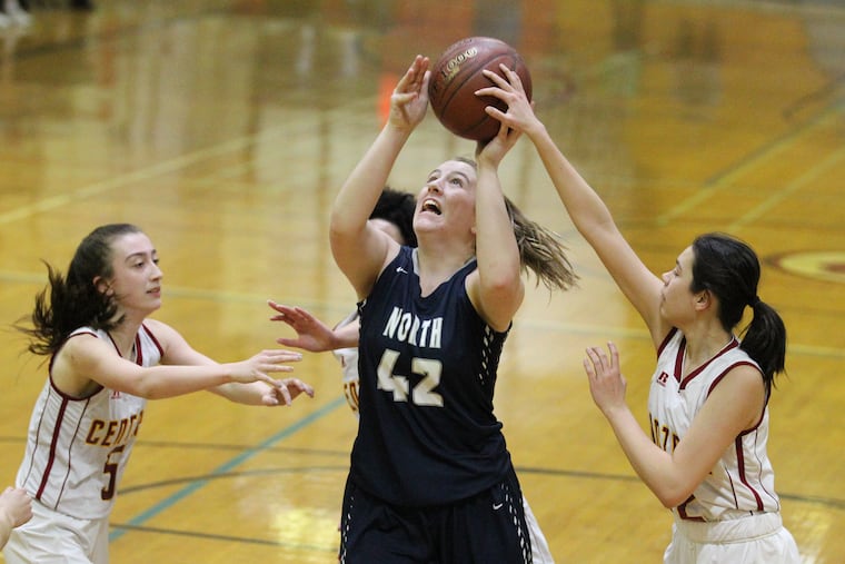 Council Rock North's Abby Jones goes up for a shot between Central's Jordan Carrier (left) and Sierra Sosa.