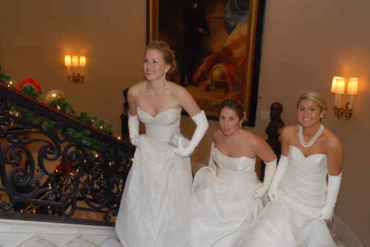 The 2009 debutantes - (from left) Virginia Grey Le Vine of Bryn Mawr, Kelley Calvert Moore of Haverford, and Marianna Del Raso of Devon - ascend the staircase at the Union League at the 130th Philadelphia Charity Ball.