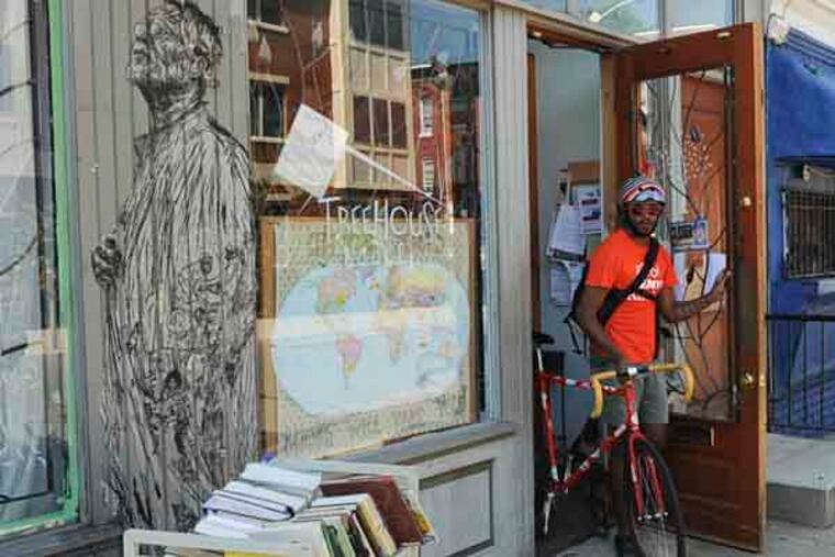 Temple student Jonathan Dasani leaves the Tree House Book store to start his rounds of delivering books for children participating in Words on Wheels, a summer literacy program in North Philadelphia. July 30, 2013 ( RON TARVER / Staff Photographer )